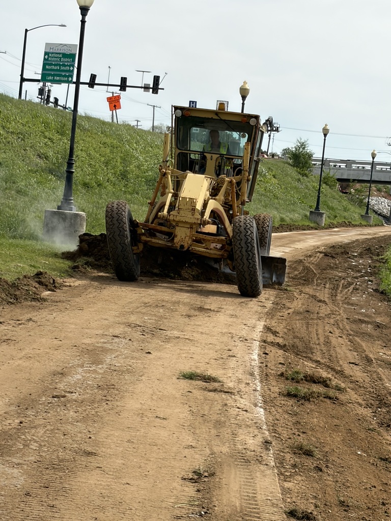 Carl Rine is cleaning off the dirt and grass on the sidewalks from the Bridge Construction.