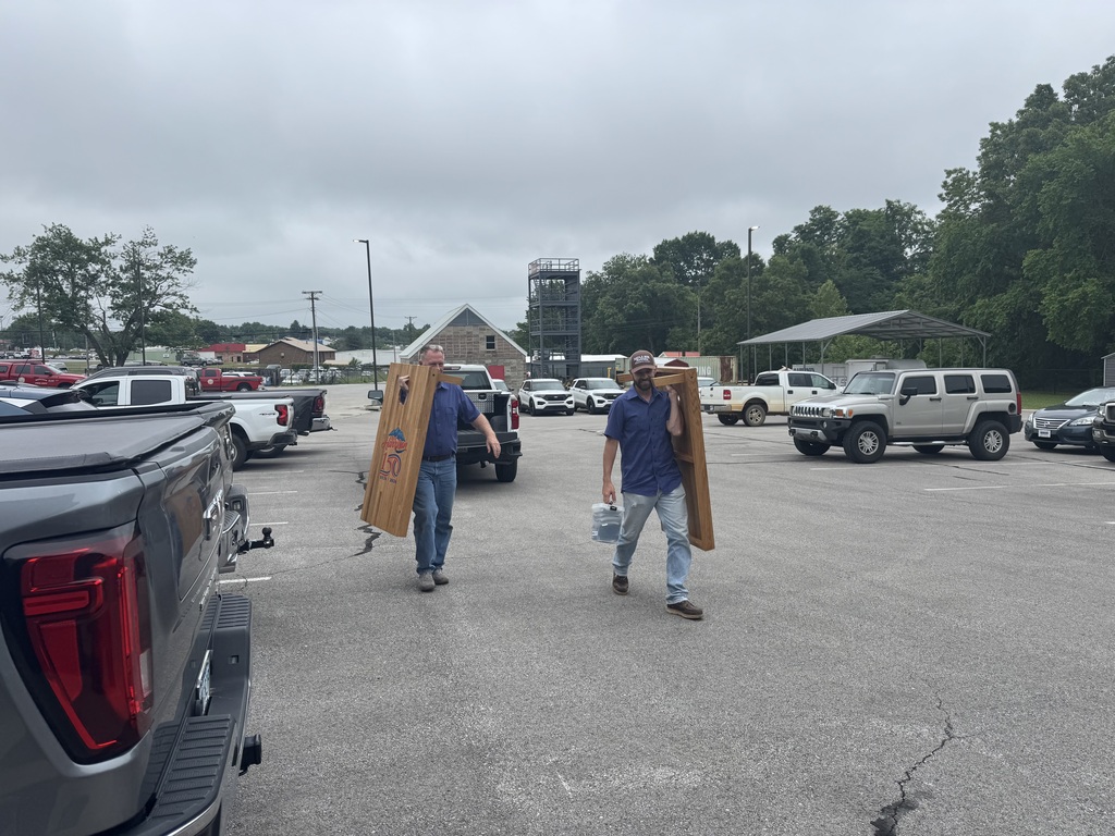 Cornhole boards being moved
