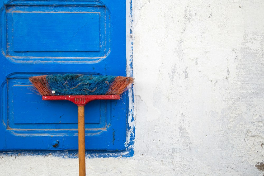 broom leaning against wall