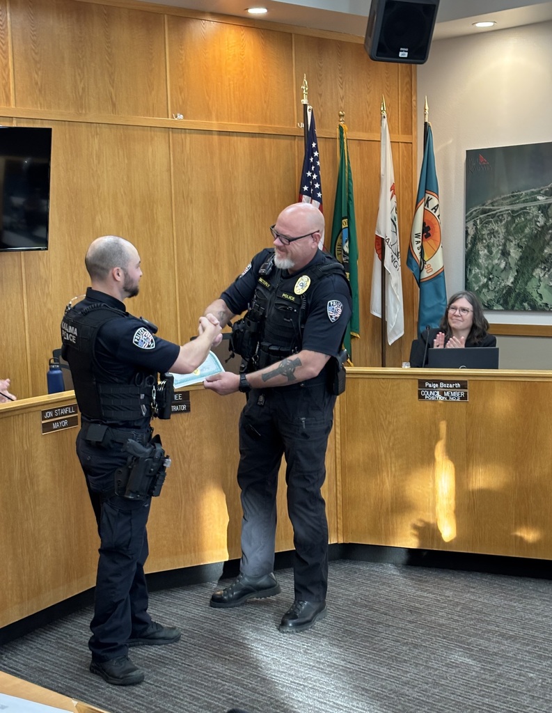 Chief Satterly gives Officer Tyler Bailey an award for meritocracy