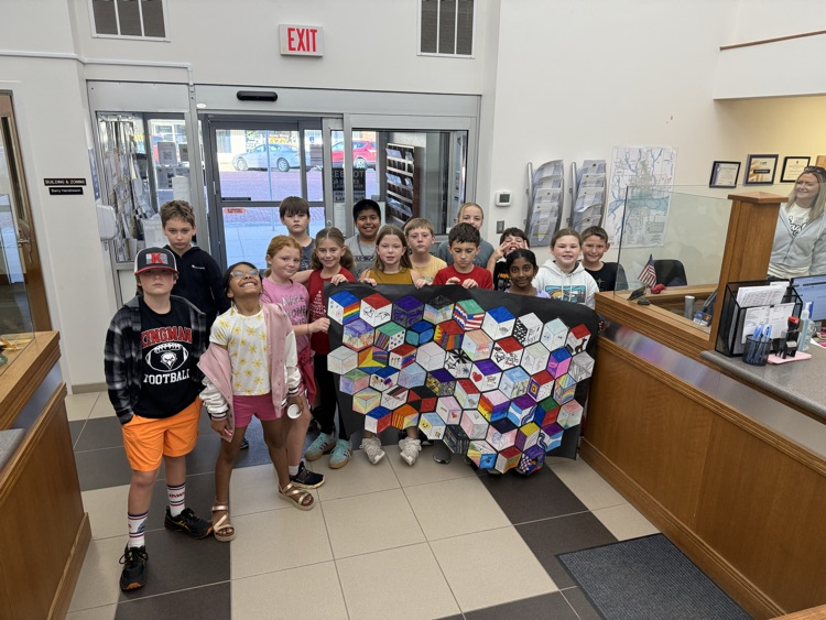 5th and 6th graders show off their artwork.