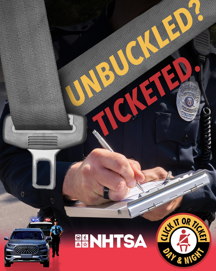 image of a law enforcement officer issuing a ticket for being unbuckled