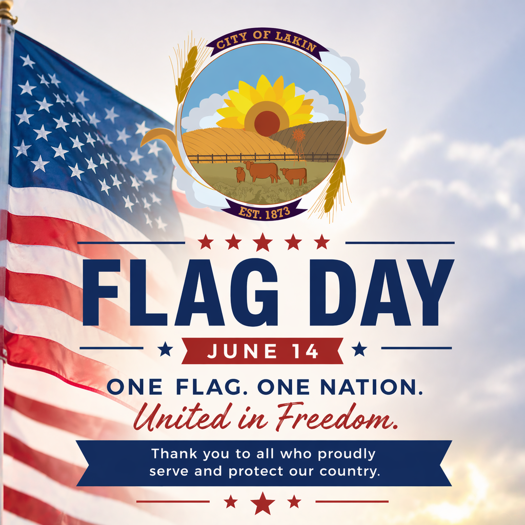 Square graphic from the City of Lakin featuring a waving American flag in the background with the City logo centered at the top. Bold text reads “Flag Day” with “June 14” underneath. Additional text says “One Flag. One Nation. United in Freedom.” and “Thank you to all who proudly serve and protect our country,” with red, white, and blue accents throughout the design.