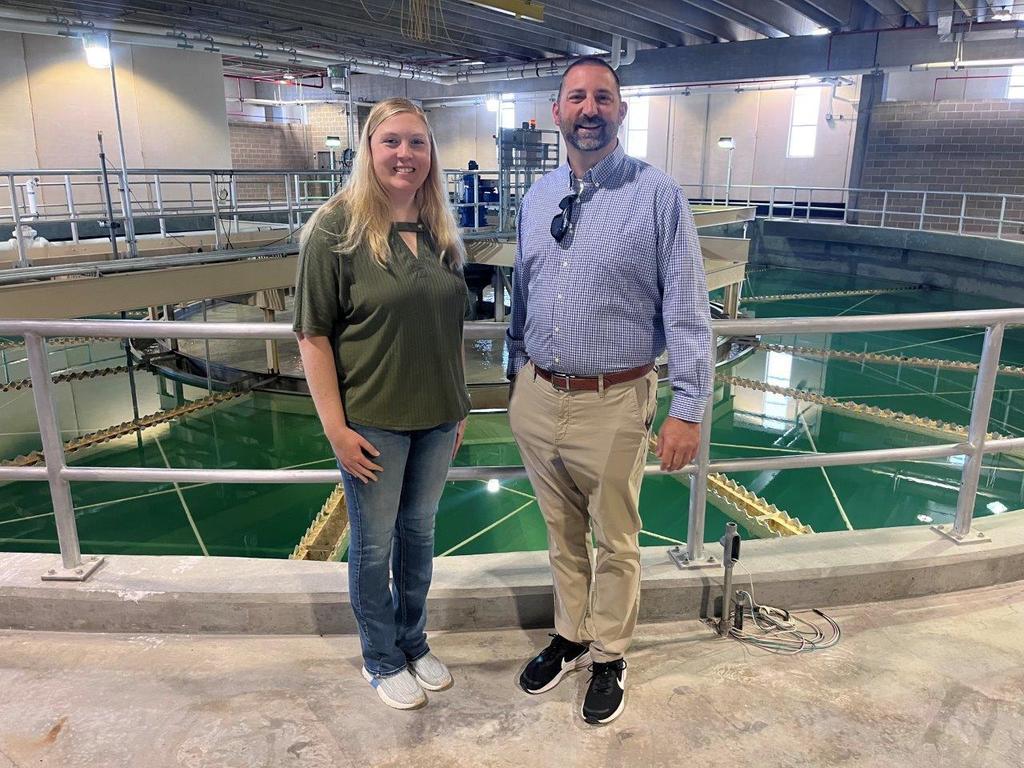 Alderman VanDriel and City Administrator Vander Plaats in front of a water softening contact basin