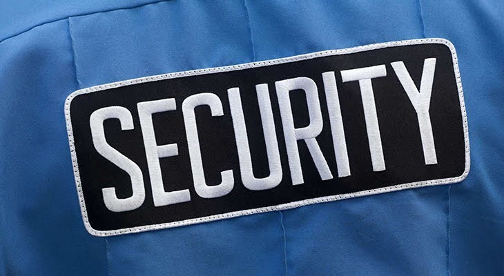 Black and white security patch on blue shirt