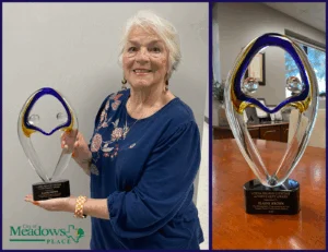 elaine brown holding recognition award