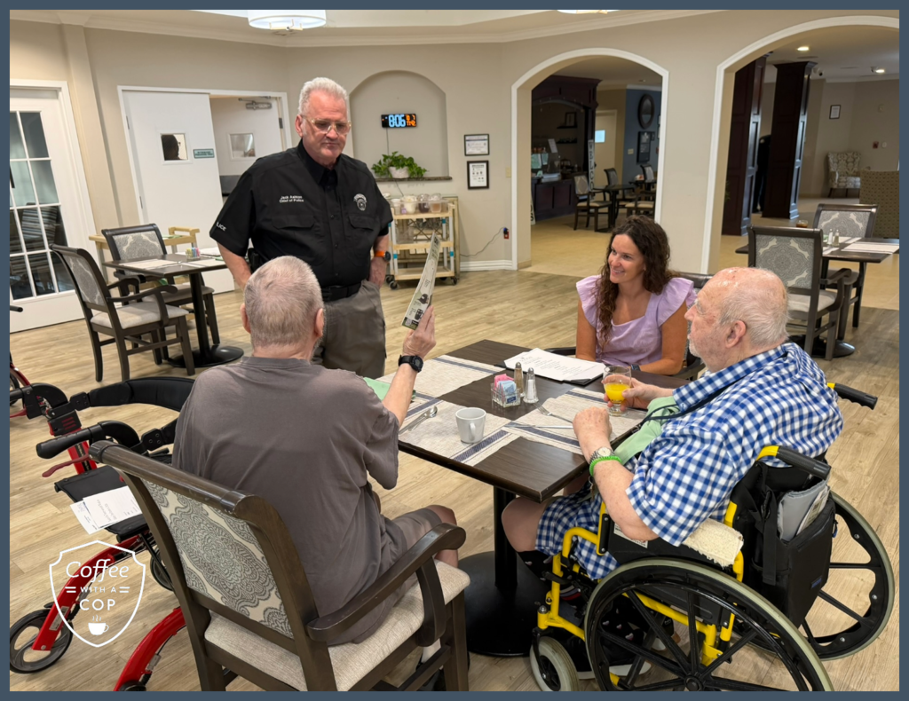 Meadows Place Police Chief Jack Ashton visits with three people seated around a dining table during Coffee with a Cop at The Jasper of Meadows Place.
