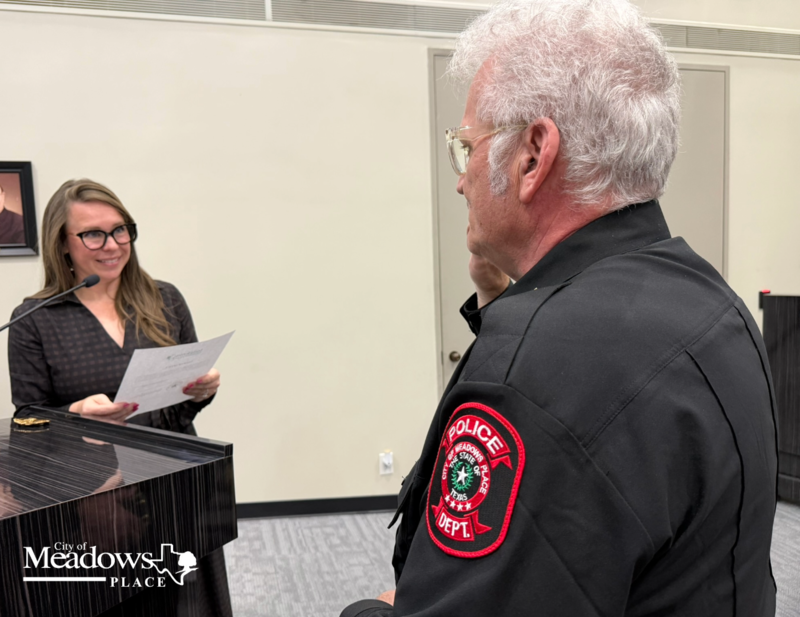 Mayor Audrey St. Germain administers the oath of office to Meadows Place Police Chief Jack Ashton during his swearing in ceremony at City Hall.