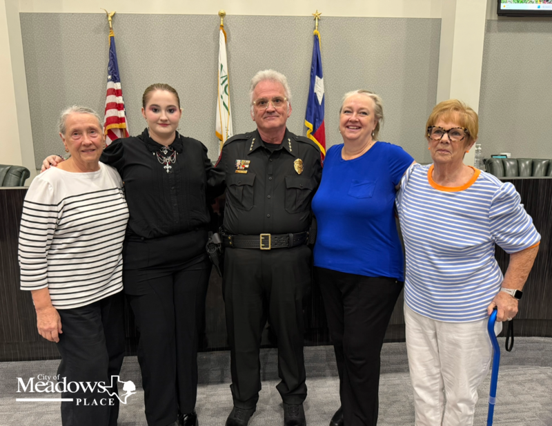 Police Chief Jack Ashton stands with family members following his swearing in ceremony at City Hall.
