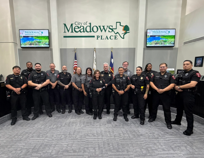 Police Chief Jack Ashton stands with members of the Meadows Place Police Department following his swearing in ceremony at City Hall.