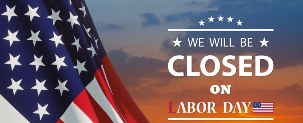 An american flag and sign saying we will be closed labor day