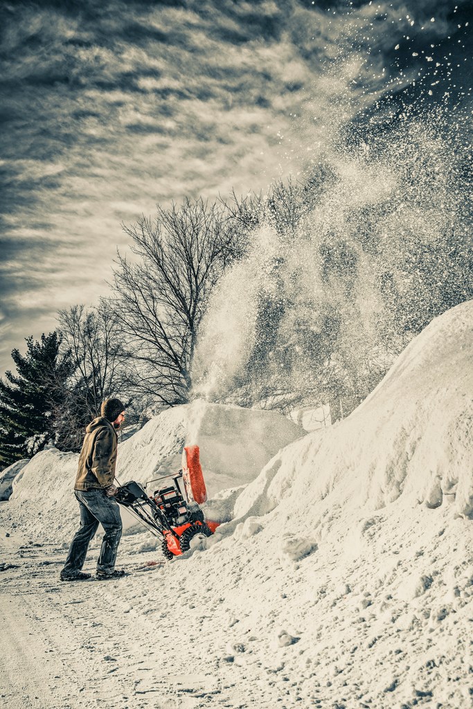 a man snowblowing