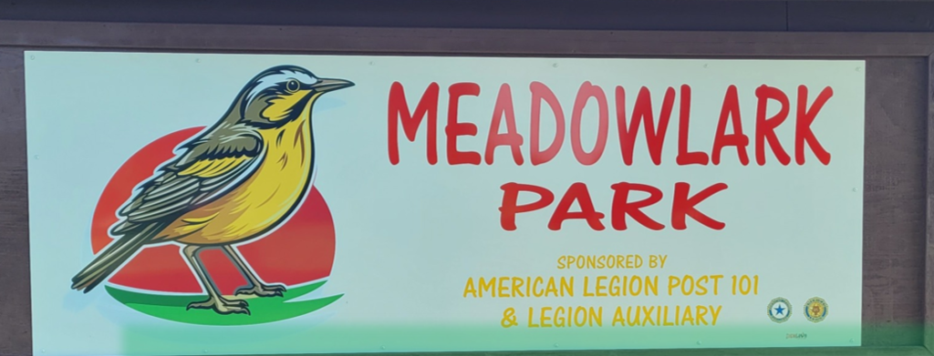 New meadowlark park sign with bird on it