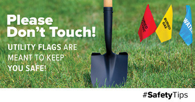 a shovel in the ground with utility flags