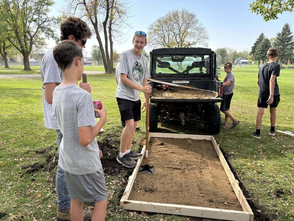 Boy scout making concrete slab