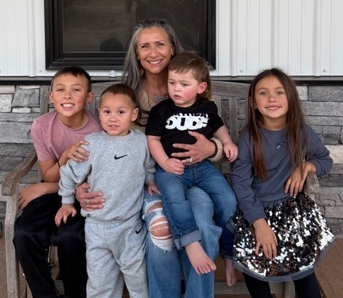 A photo of Norma Brown with her grandchildren.