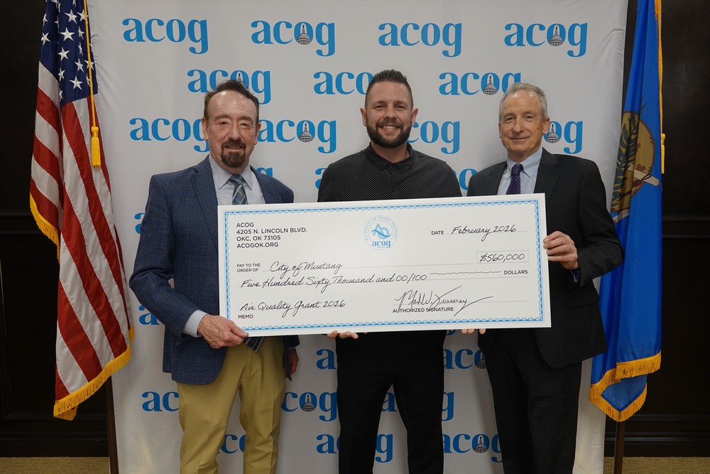 Grant check being presented to Vice Mayor Sholund from ACOG Officials