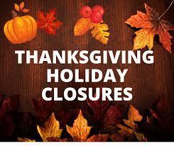 Sign that reads "Thanksgiving Holiday Closures with leaves and pumpkins