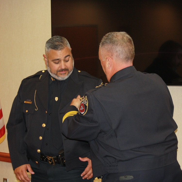 sergeant Ben Trujillo receiving his promotion bars