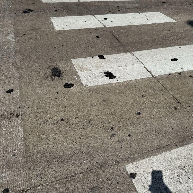  crosswalk with chunks of asphalt