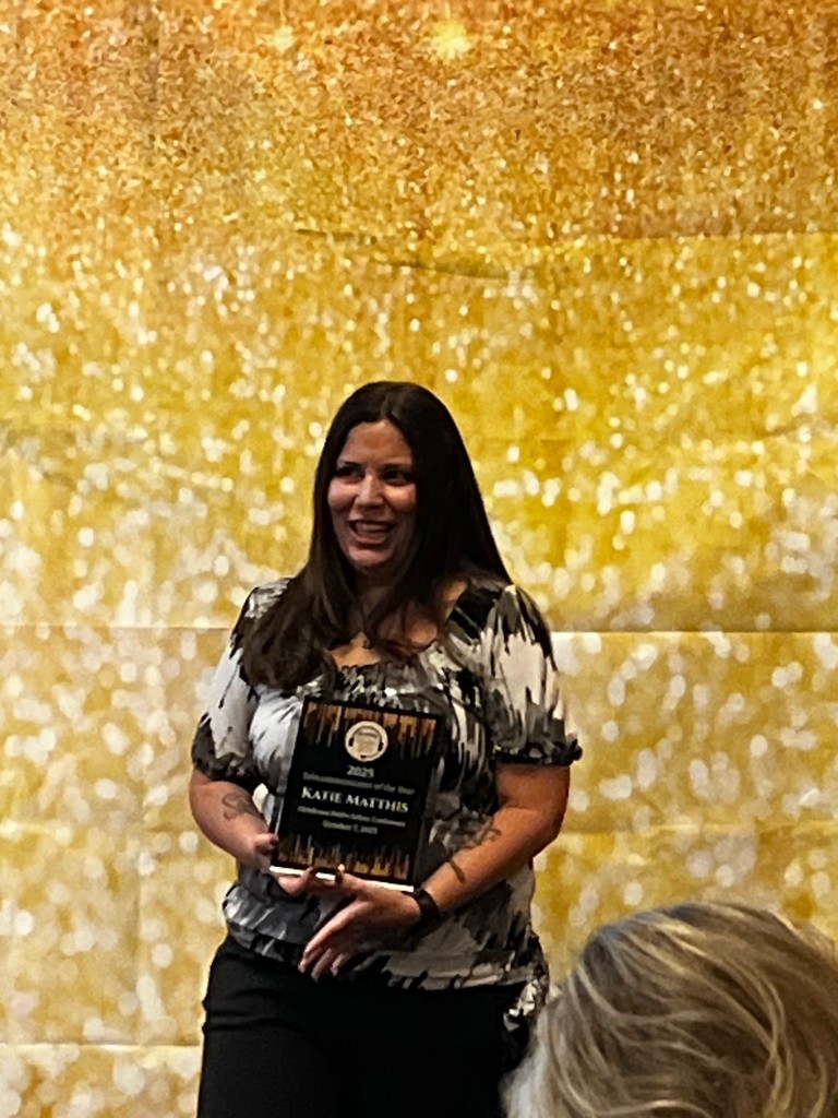 A photo of Katie Matthis receiving her award