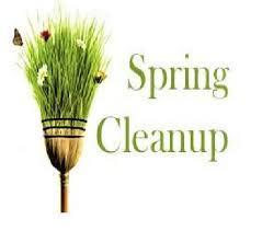 The words Spring Clean-Up with a broom that turns into grass and butterflies