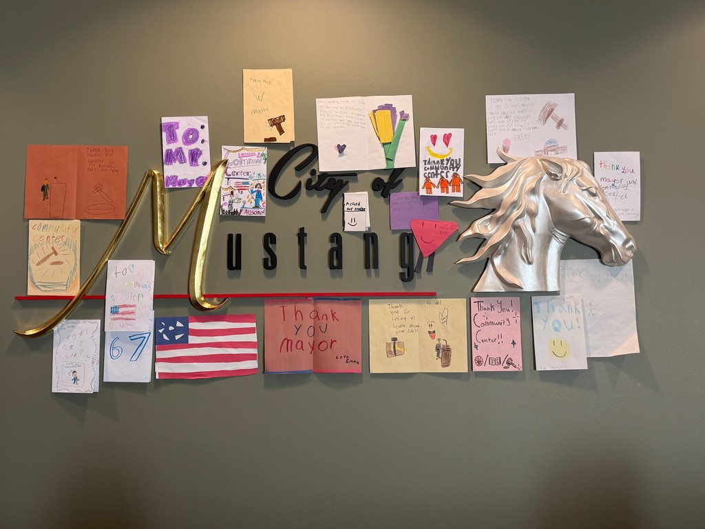 A photo of thank you notes around the City of Mustang logo in Council Chambers