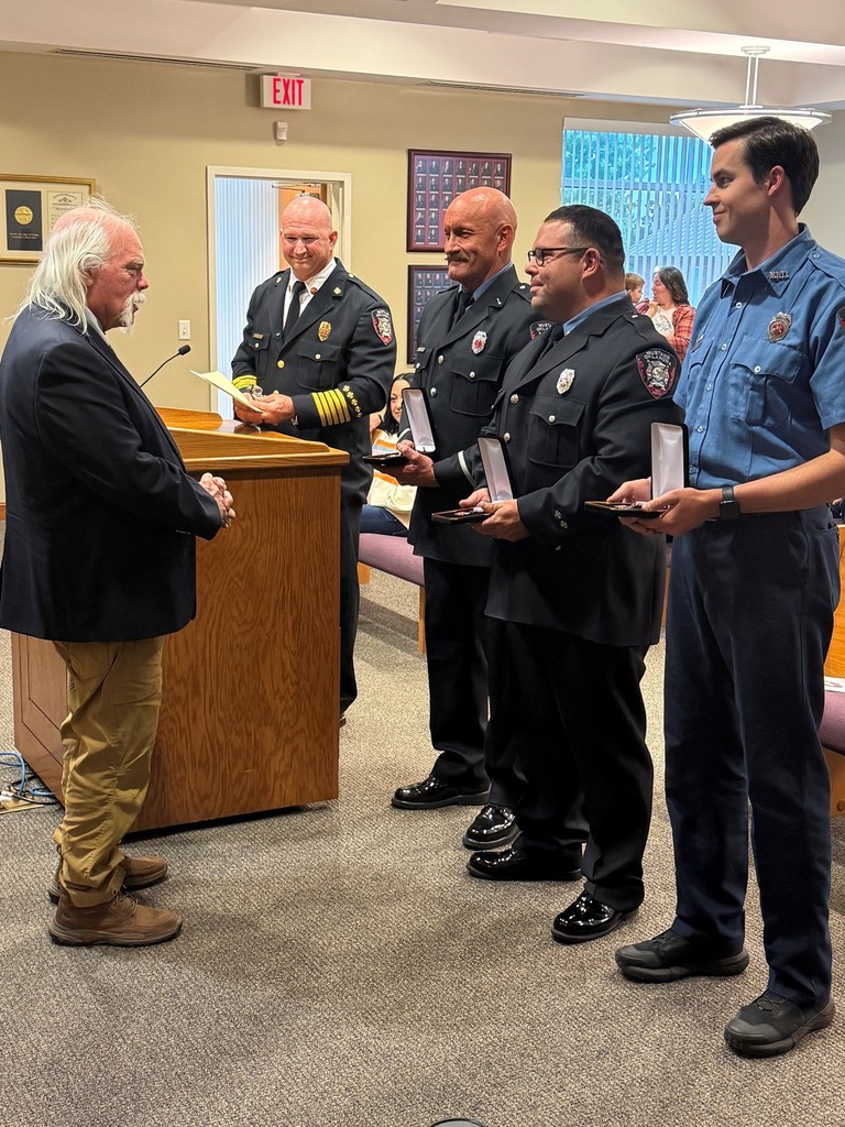 Life Saving Awards being presented to Fire Fighters by Mr. Mike Mason at a City Council Meeting