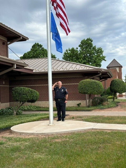 Chief Wallace saluting at Peace Officer Memorial Ceremony