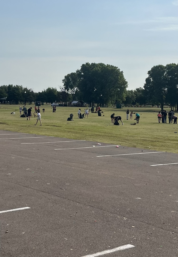 people in a park picking up litter