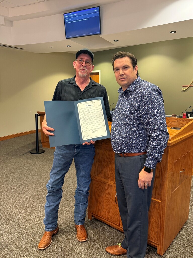 Mr. Shane Huck receiving a Proclamation from Mayor Michael Ray