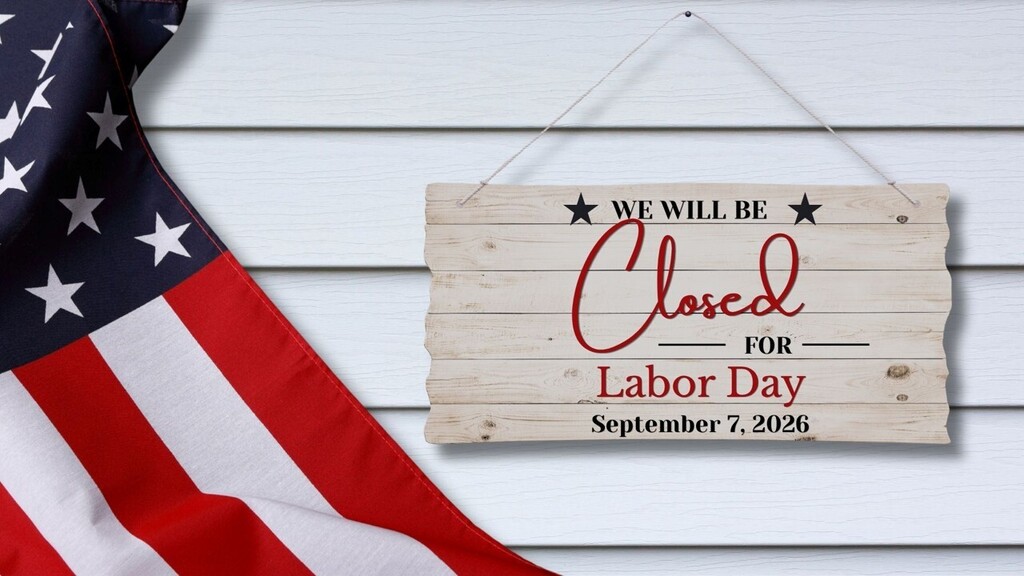 A sign that says we will be closed on Labor Day, September 7, 2026 with part of the US flag