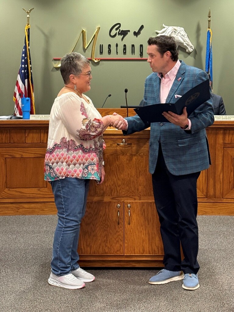 Ms. Teresa DeBord receiving a Proclamation from Mayor Ray