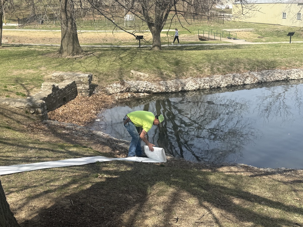 city worker Kenny unfolding the tube to put it into the lagoon