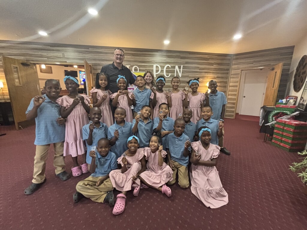 Mayor mendenhall and his wife christi with the little feet organization children in the nazarine church