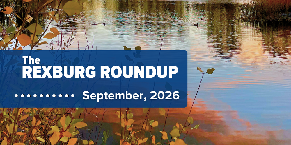 text "Rexburg Roundup .... September, 2026" on a navy rectangle over a photo of a reflected sunset and trees on the water with ducks and yellow & green color-changing foliage in the foreground