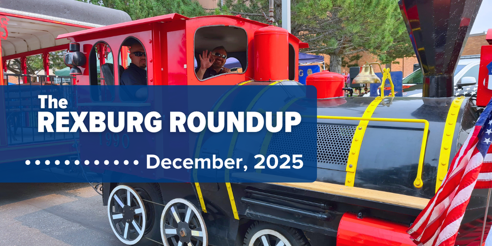 train with two drivers in the engine waving