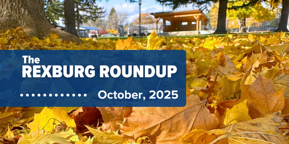"Rexburg Roundup ... October 2025" on a navy rectangle over a photo of yellow fallen leaves with Beehive Pavilion in Porter Park in the background.