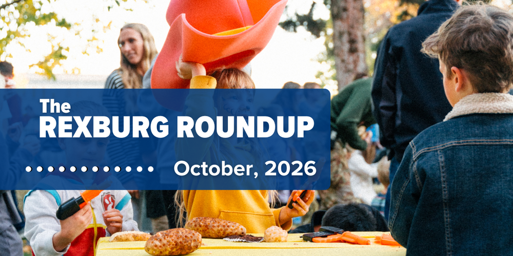 "The Rexburg Roundup...October 2026" on a semi-transparent blue rectangle over a photo of children at a table outdoors in autumn, potatoes on the table, young girl is holding a large felt cowboy hat over her head lots of other people and activity is happening in the background.