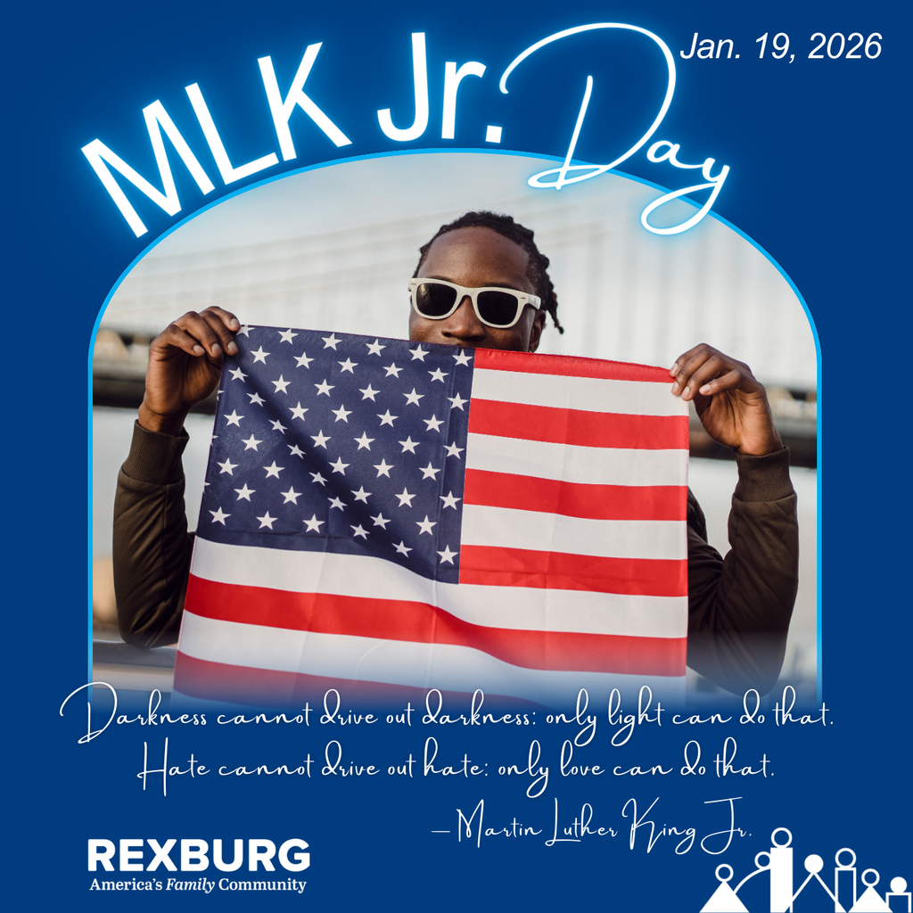 A young black man in white sunglasses holding up an American Flag up to his nose and text "Darkness cannot drive out darkness: only light can do that.  Hate cannot drive out hate: only love can do that. MLK Jr.; MLK Jr Day; Jan. 19, 2026; Rexburg logos" 