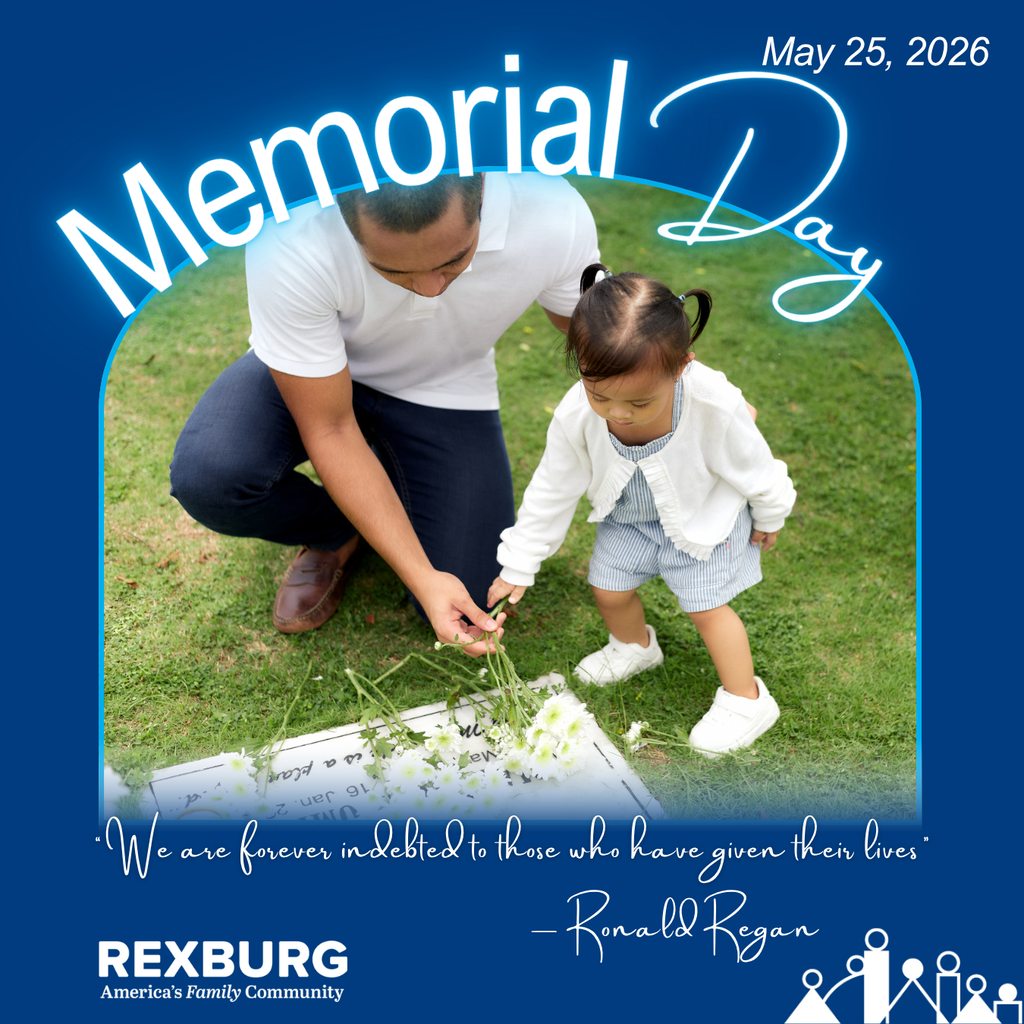 a man and his young daughter lay white flowers on a gravestone that is flat to the ground with manicured green grass around them. plus text "Memorial Day, May 25, 2026, 'We are forever indebted to those who have given their lives.' - Ronald Regan" with the Rexburg logo and a darker blue background.