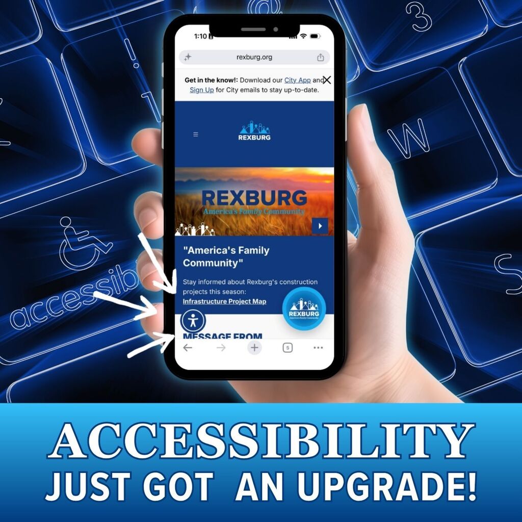 A hand holds a smartphone displaying the Rexburg city website and arrows point to an accessibility icon in the lower left of the screen. Text reads "Accessibility Just Got an Upgrade!" Blue background with keyboard keys.