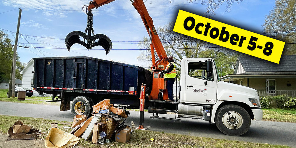 Grapple truck picking up debris