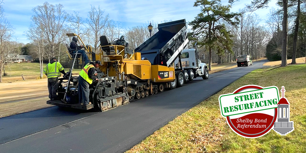 Street paving equipment laying down asphalt