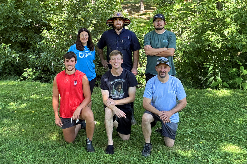 Group photo of 6 creek cleanup event volunteers beside creek