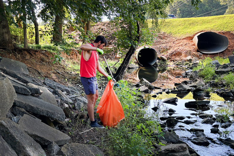 Volunteers collecting trash from the creek