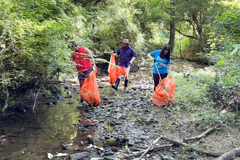 Volunteers collecting trash from the creek