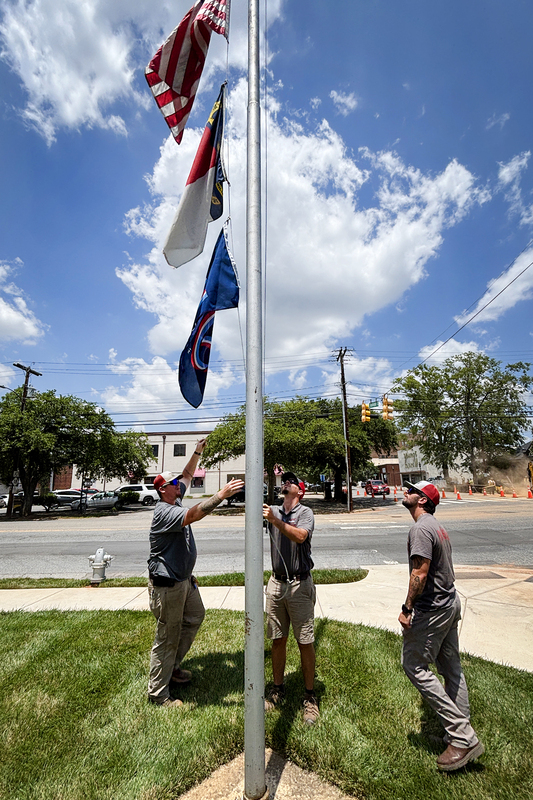 City Park staff hanging the America 250 flag