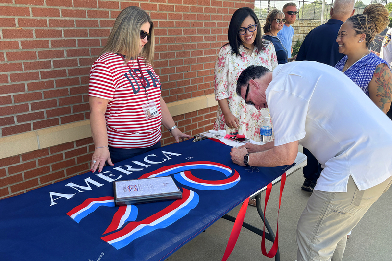 The Mayor signing the America 250 flag