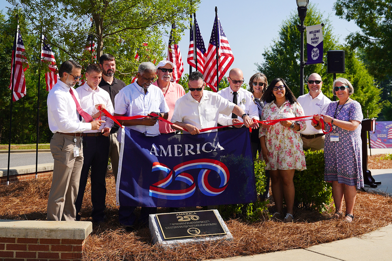 Group of people unveiling the bronze plaque